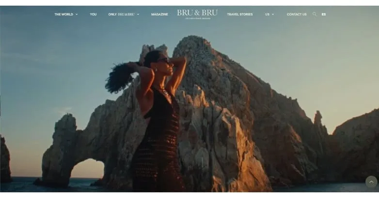 BRU&BRU luxury travel homepage with a full-screen rock arch at sunset