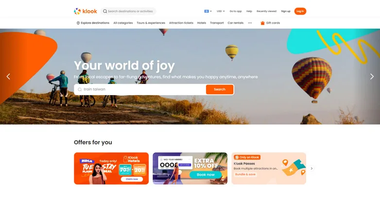 Klook homepage with a Your world of joy hero and hot air balloons